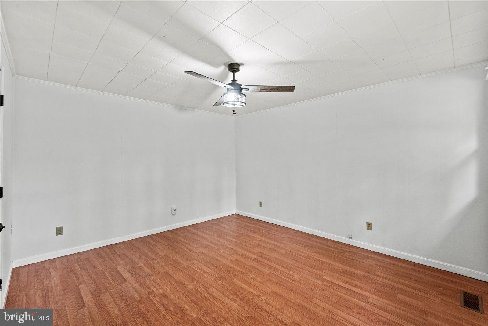 679 Resettlement Road Madison, VA 22727 - Photo 24 of 47 a view of a room with wooden floor and a ceiling fan