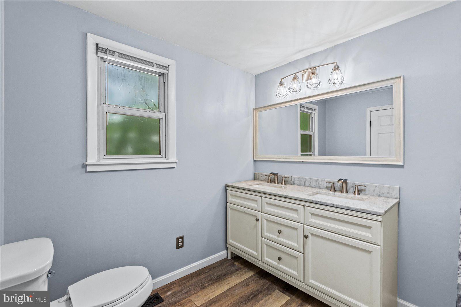 679 Resettlement Road Madison, VA 22727 - Photo 26 of 47 a bathroom with a toilet sink vanity and mirror