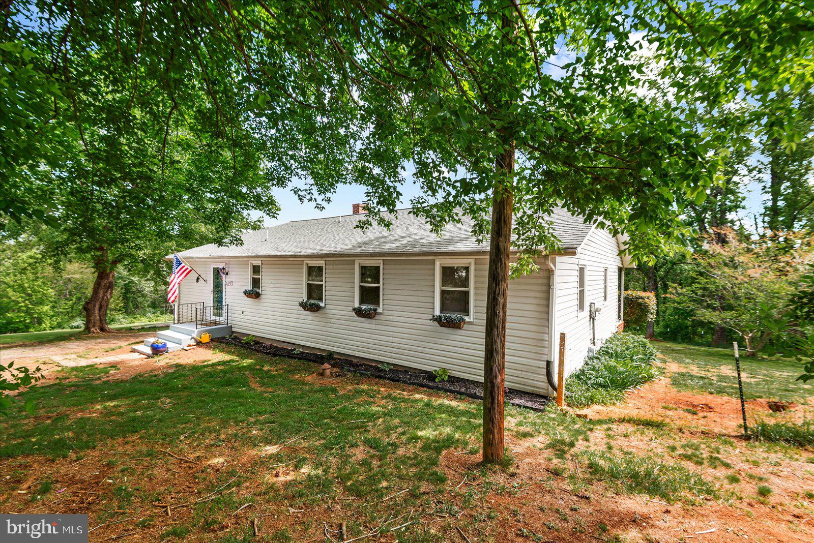 679 Resettlement Road Madison, VA 22727 - Photo 4 of 47 a front view of a house with garden