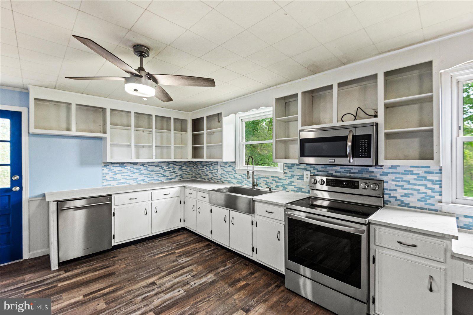 679 Resettlement Road Madison, VA 22727 - Photo 8 of 47 a kitchen with stainless steel appliances granite countertop a stove and a sink