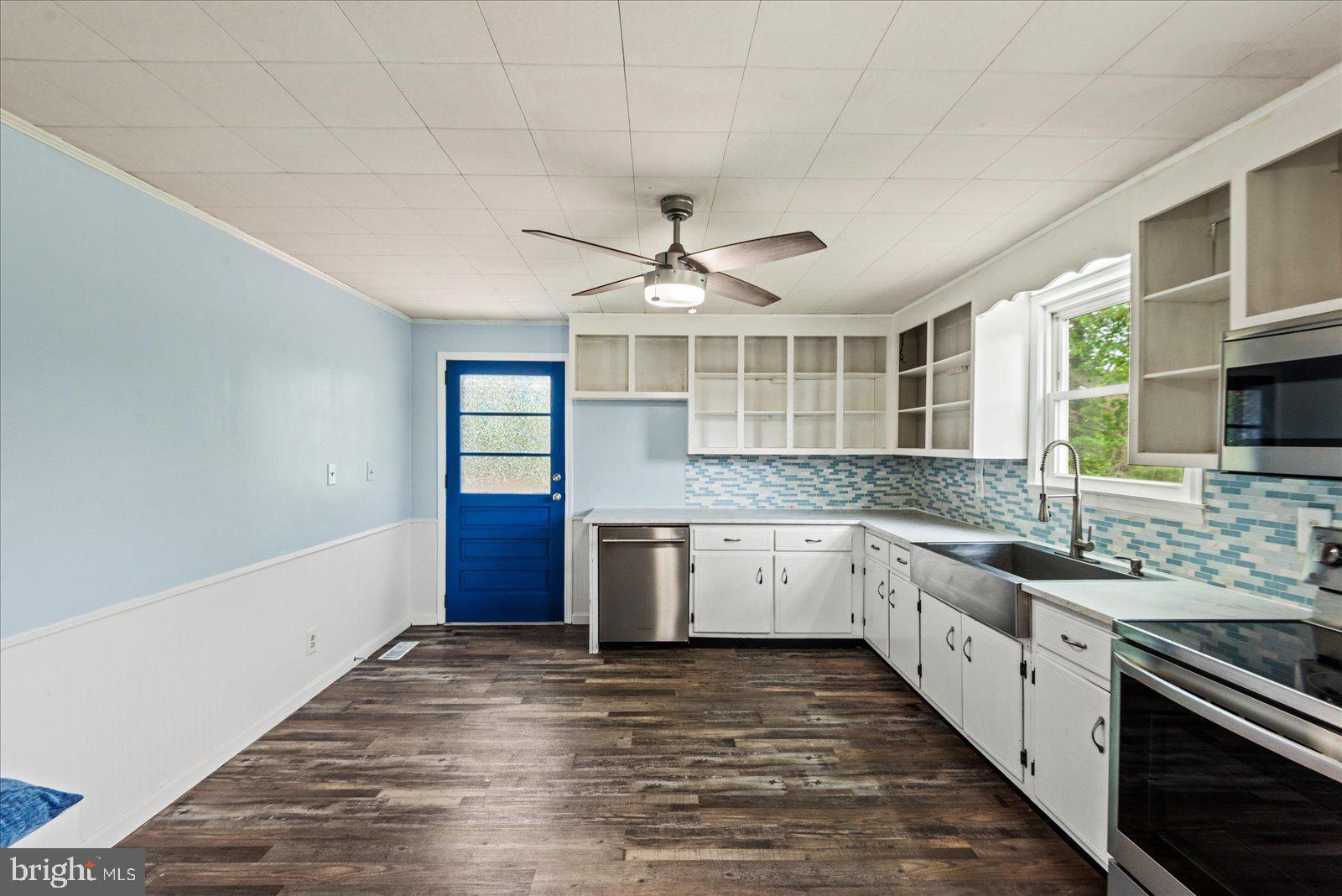 679 Resettlement Road Madison, VA 22727 - Photo 9 of 47 a large kitchen with granite countertop a stove and a sink