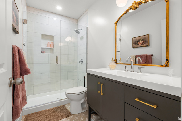2706 West Maple Street, Unit 285 Mapleton, UT 84664 - Photo 27 of 36 Bathroom featuring a glass-enclosed shower with white tiled walls and built-in shelving