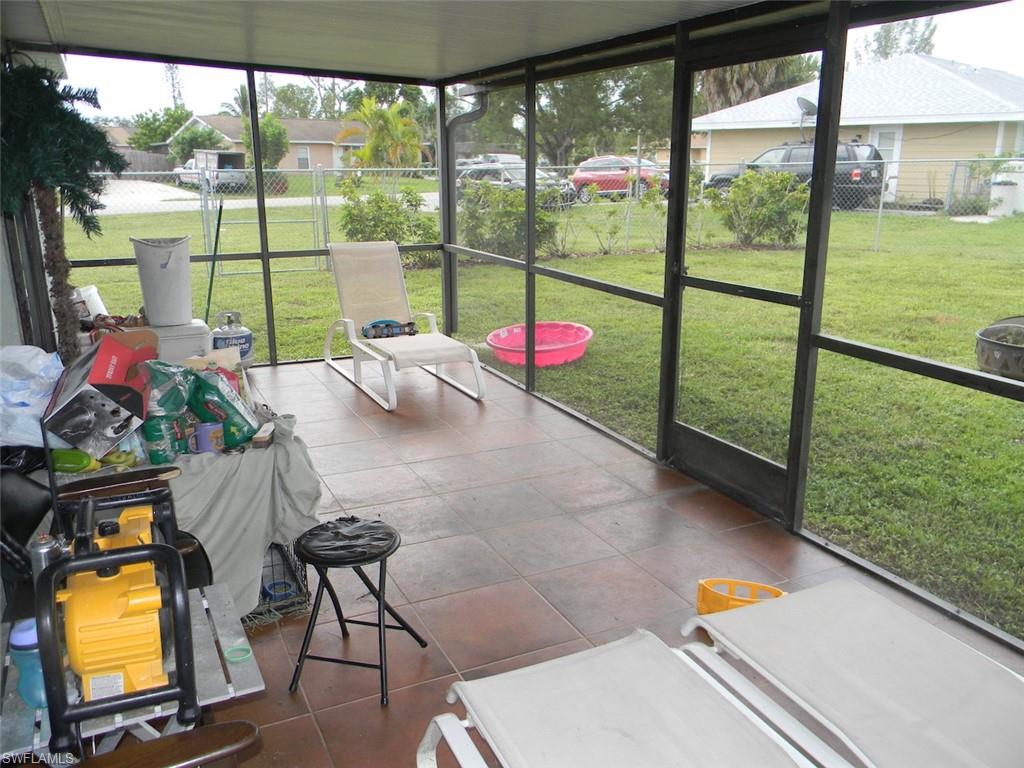4448 30th Place Southwest Naples, FL 34116 - Photo 14 of 19 a view of a living room and floor to ceiling window or wooden floor