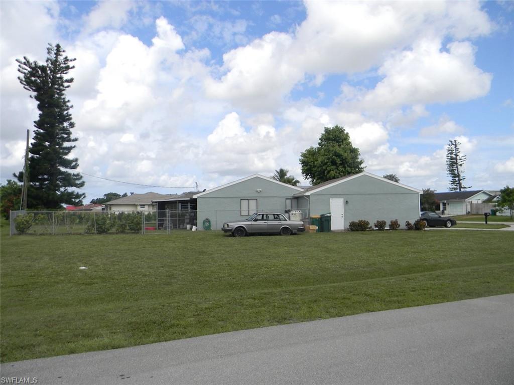 4448 30th Place Southwest Naples, FL 34116 - Photo 16 of 19 a front view of a house with a yard