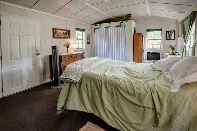 an aerial view of residential houses with outdoor space and trees