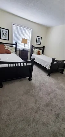 a bedroom with bed and window