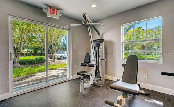 a room with gym equipment and a large window