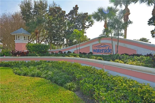 a view of a house with a yard and a bench