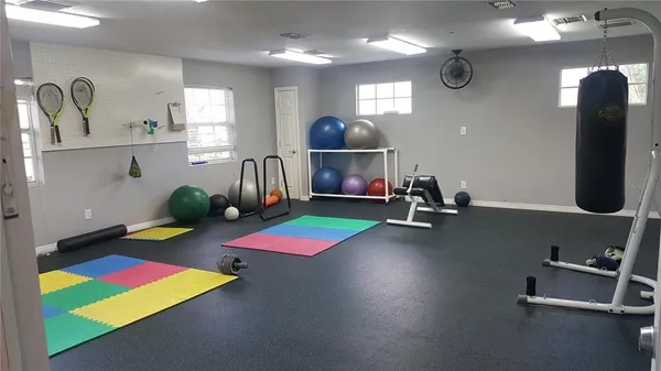 a room with pool table table soccer and windows