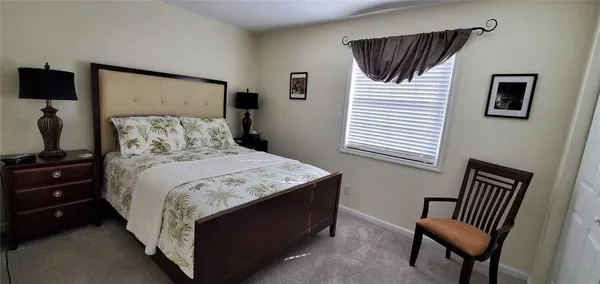 a bedroom with a bed and a potted plant