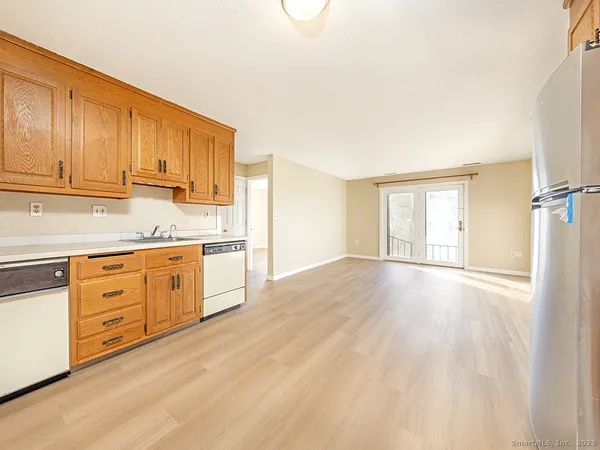 a kitchen with granite countertop white cabinets and white appliances