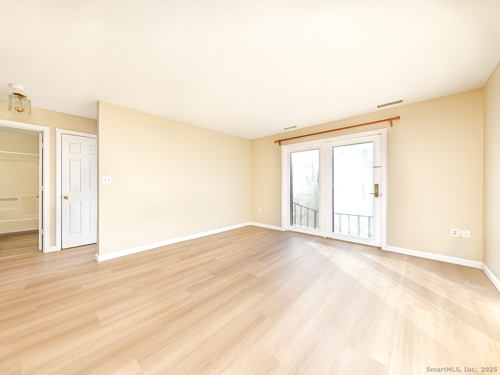 50 Long Street, Unit 5 New Britain, CT 06051 - Photo 5 of 16 a view of an empty room with wooden floor and a window