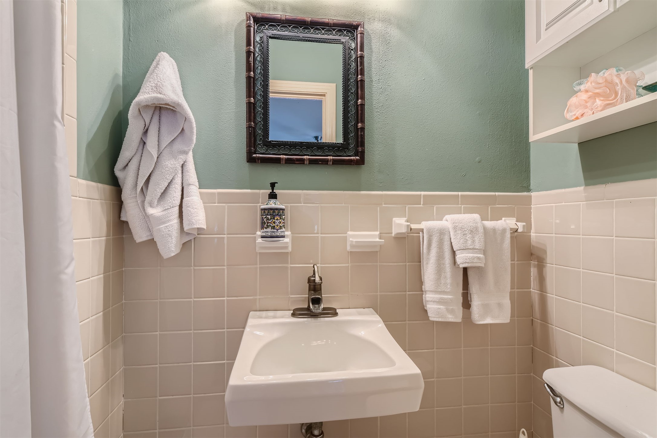 6804 Vine Street Austin, TX 78757 - Photo 12 of 15 a bathroom with a sink a toilet and mirror