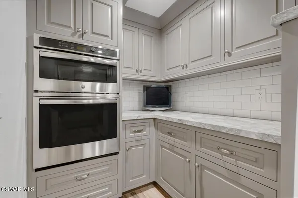 a kitchen with granite countertop white cabinets stainless steel appliances and sink
