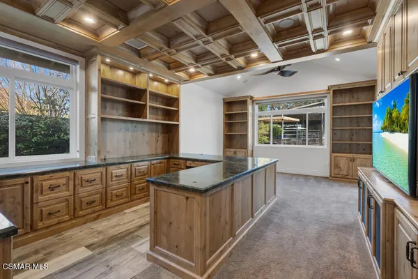 a kitchen with granite countertop a sink and a stove