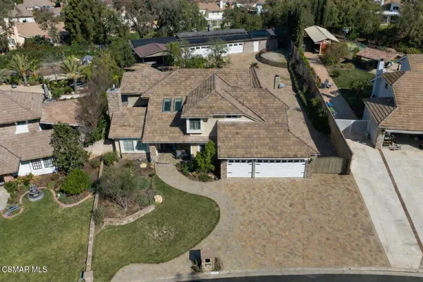 an aerial view of a house with a yard basket ball court and outdoor seating