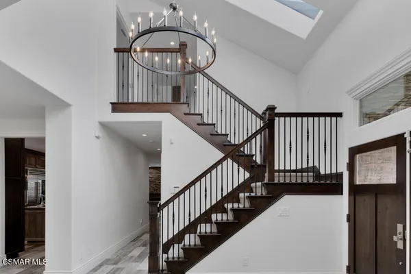 a view of staircase with wooden floor and a large window