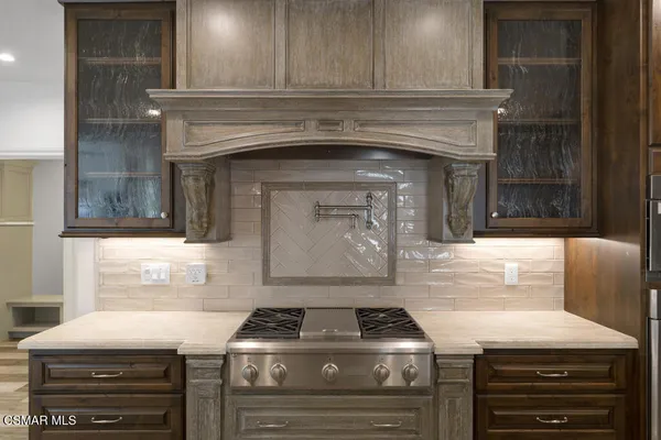 a stove top oven sitting inside of a kitchen