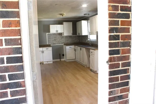 a view of a kitchen with a sink and cabinets