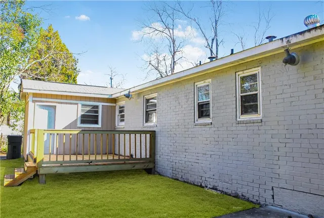 a view of a house with a wooden deck