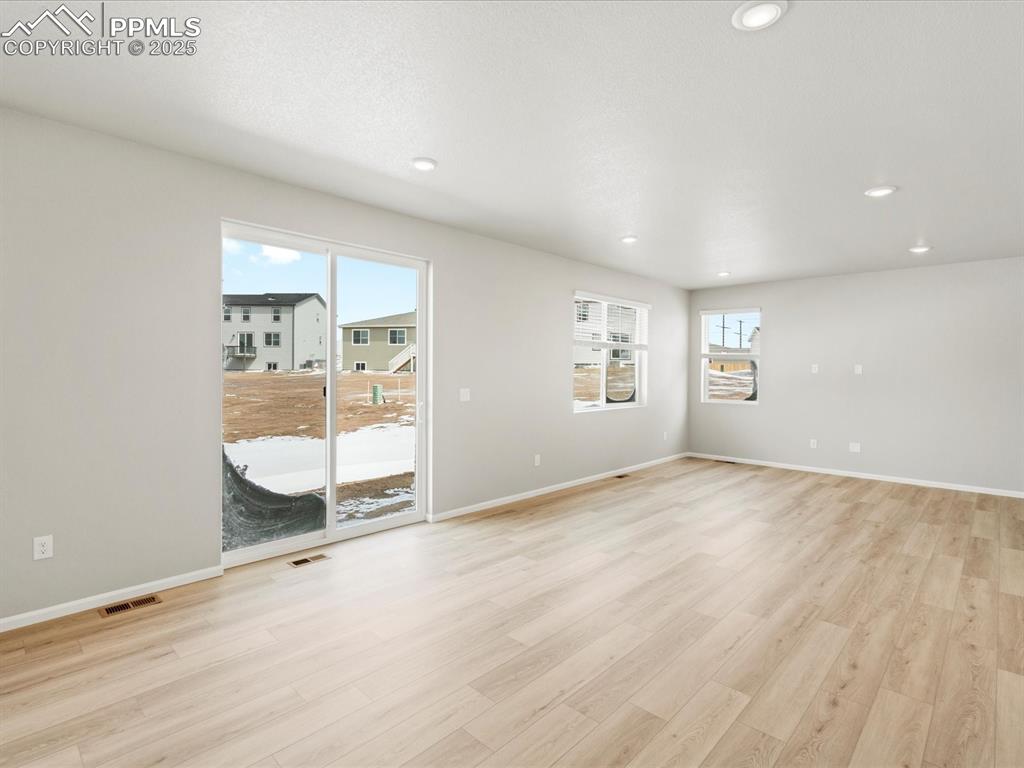 10636 Waterloo Drive Peyton, CO 80831 - Photo 13 of 36 Unfurnished room featuring visible vents, recessed lighting, light wood-type flooring, and baseboards