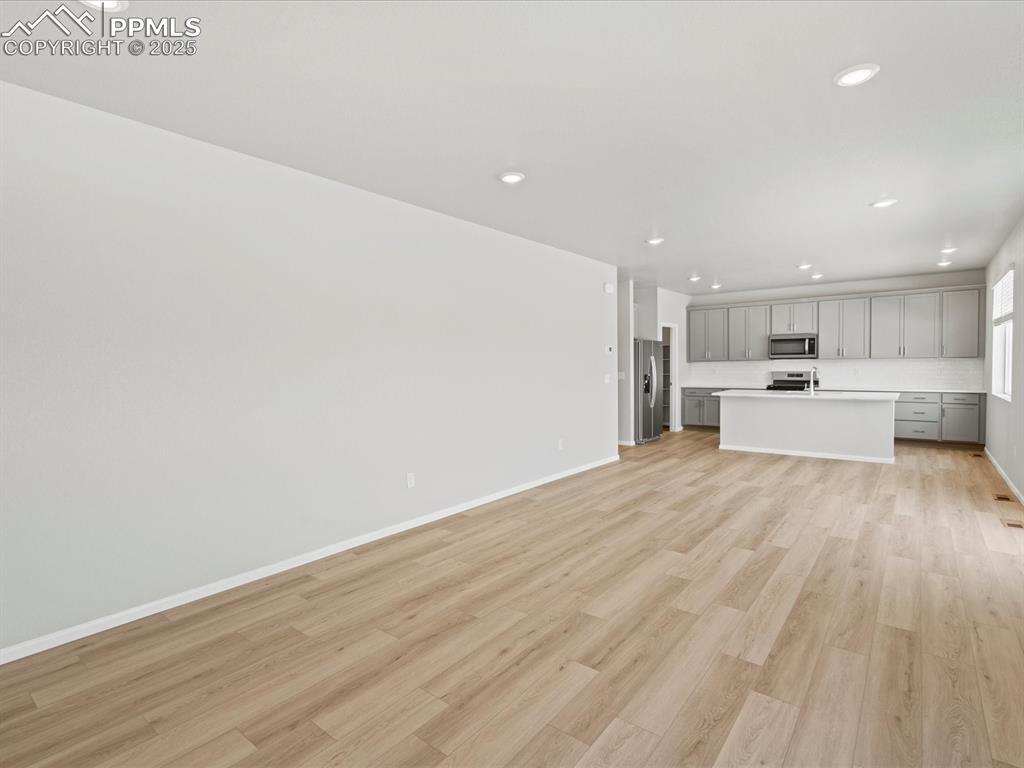 10636 Waterloo Drive Peyton, CO 80831 - Photo 14 of 36 Unfurnished living room with light wood finished floors, recessed lighting, and baseboards