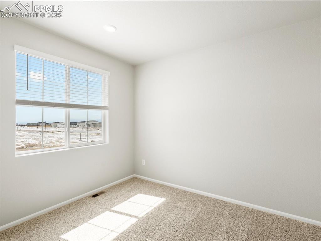10636 Waterloo Drive Peyton, CO 80831 - Photo 16 of 36 Carpeted spare room featuring visible vents and baseboards