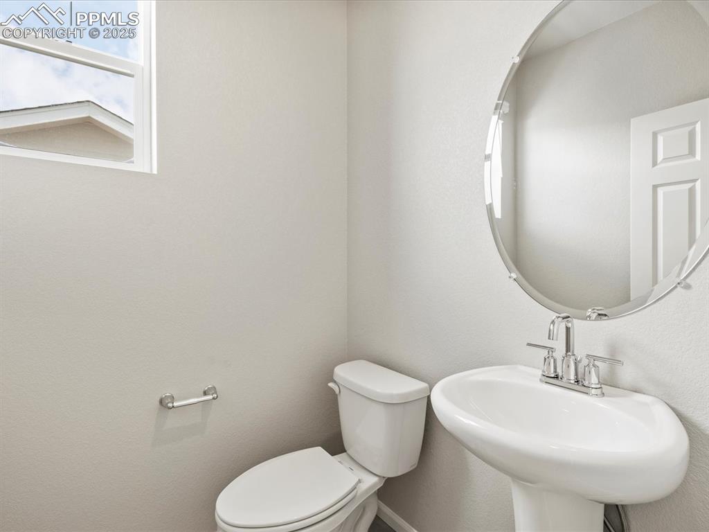 10636 Waterloo Drive Peyton, CO 80831 - Photo 17 of 36 Half bath featuring toilet and a sink