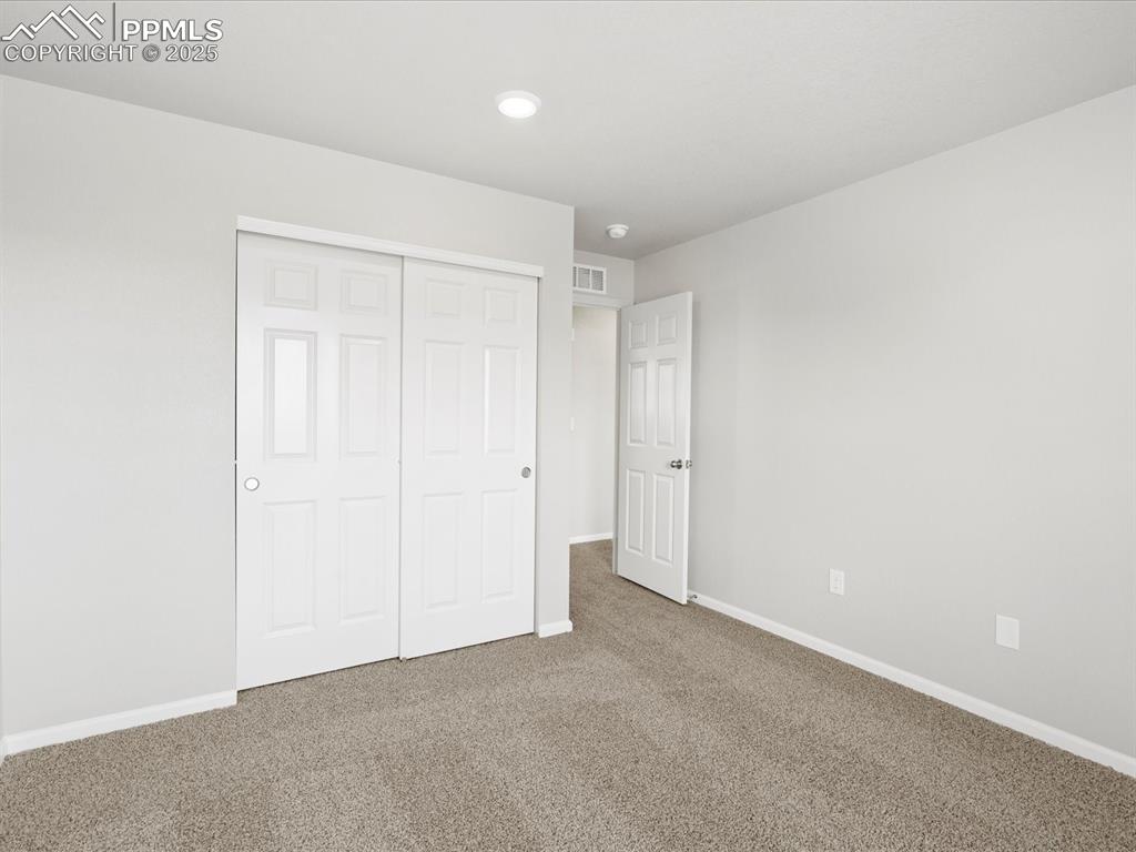 10636 Waterloo Drive Peyton, CO 80831 - Photo 28 of 36 Unfurnished bedroom with a closet, visible vents, carpet flooring, and baseboards