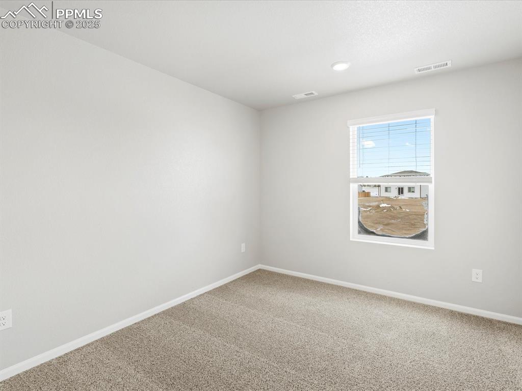10636 Waterloo Drive Peyton, CO 80831 - Photo 29 of 36 Empty room with visible vents, baseboards, and carpet