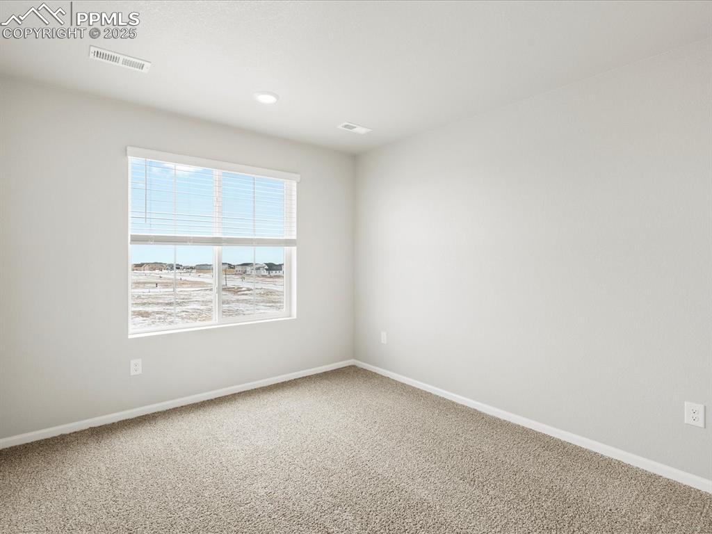 10636 Waterloo Drive Peyton, CO 80831 - Photo 31 of 36 Carpeted empty room featuring visible vents and baseboards