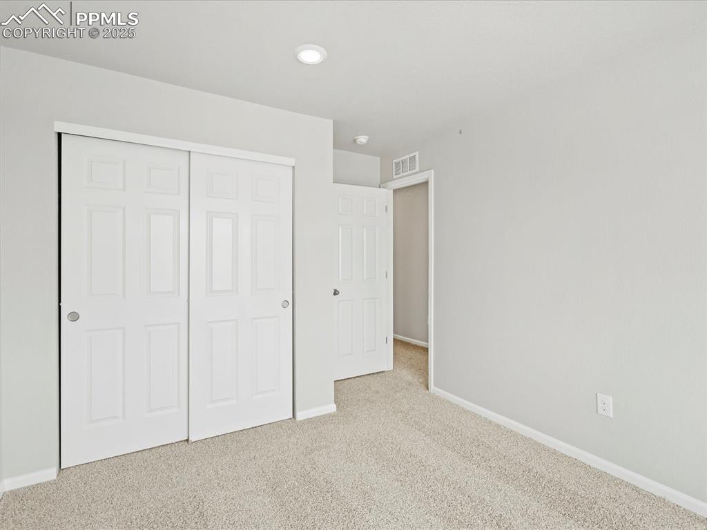 10636 Waterloo Drive Peyton, CO 80831 - Photo 32 of 36 Unfurnished bedroom featuring a closet, visible vents, carpet flooring, and baseboards