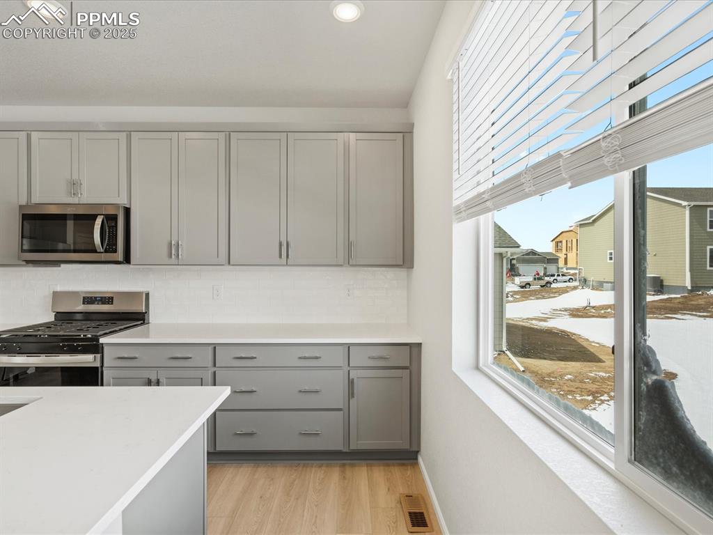 10636 Waterloo Drive Peyton, CO 80831 - Photo 5 of 36 Kitchen with plenty of natural light, visible vents, gray cabinets, and stainless steel appliances