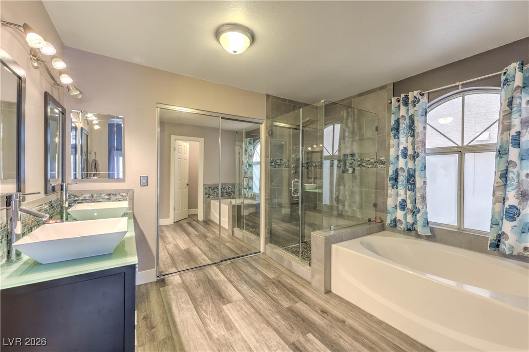 9405 Crosspointe Avenue Las Vegas, NV 89117 - Photo 12 of 37 Downstairs Primary Bathroom w/ Upgraded double sink vanity, standing shower, and walk in closet.