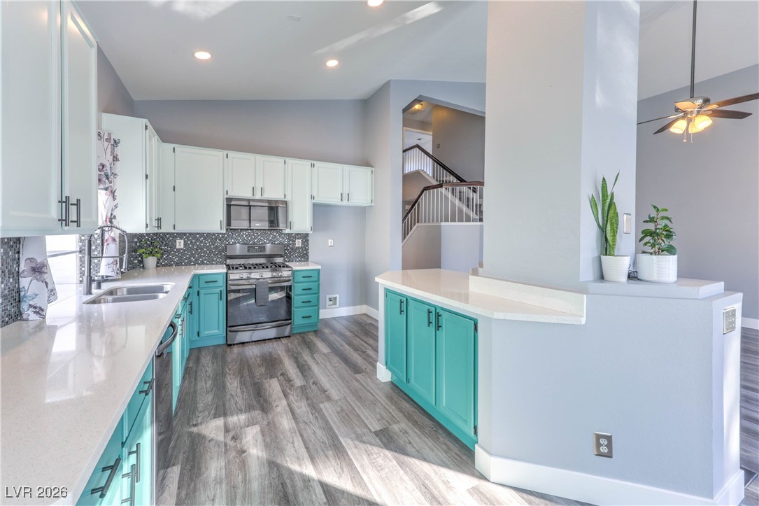9405 Crosspointe Avenue Las Vegas, NV 89117 - Photo 17 of 37 Upgraded kitchen with Quartz countertops, Backsplash, Black Stainless Appliances, and Painted Cabinets w/ ton of storage!