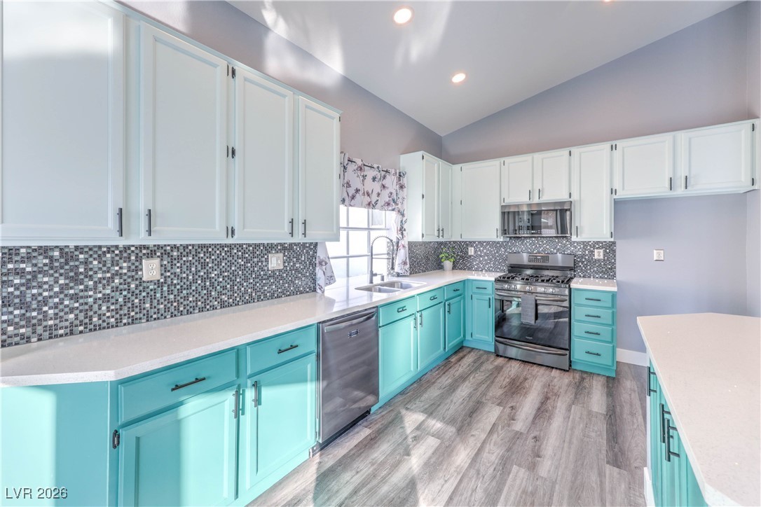 9405 Crosspointe Avenue Las Vegas, NV 89117 - Photo 18 of 37 Upgraded kitchen with Quartz countertops, Backsplash, Black Stainless Appliances, and Painted Cabinets w/ ton of storage!
