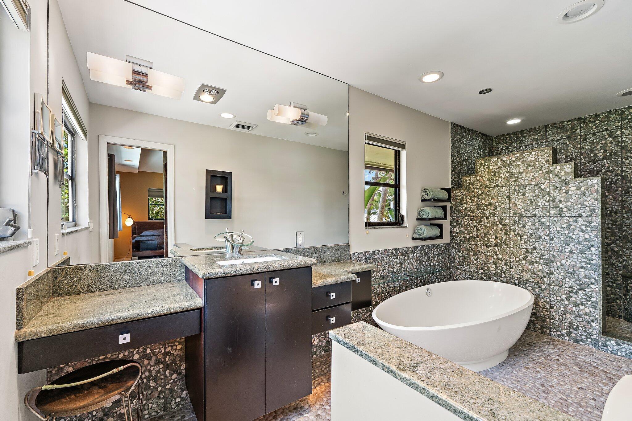 702 Warren Drive Jupiter, FL 33458 - Photo 55 of 76 a bathroom with a granite countertop sink and a mirror