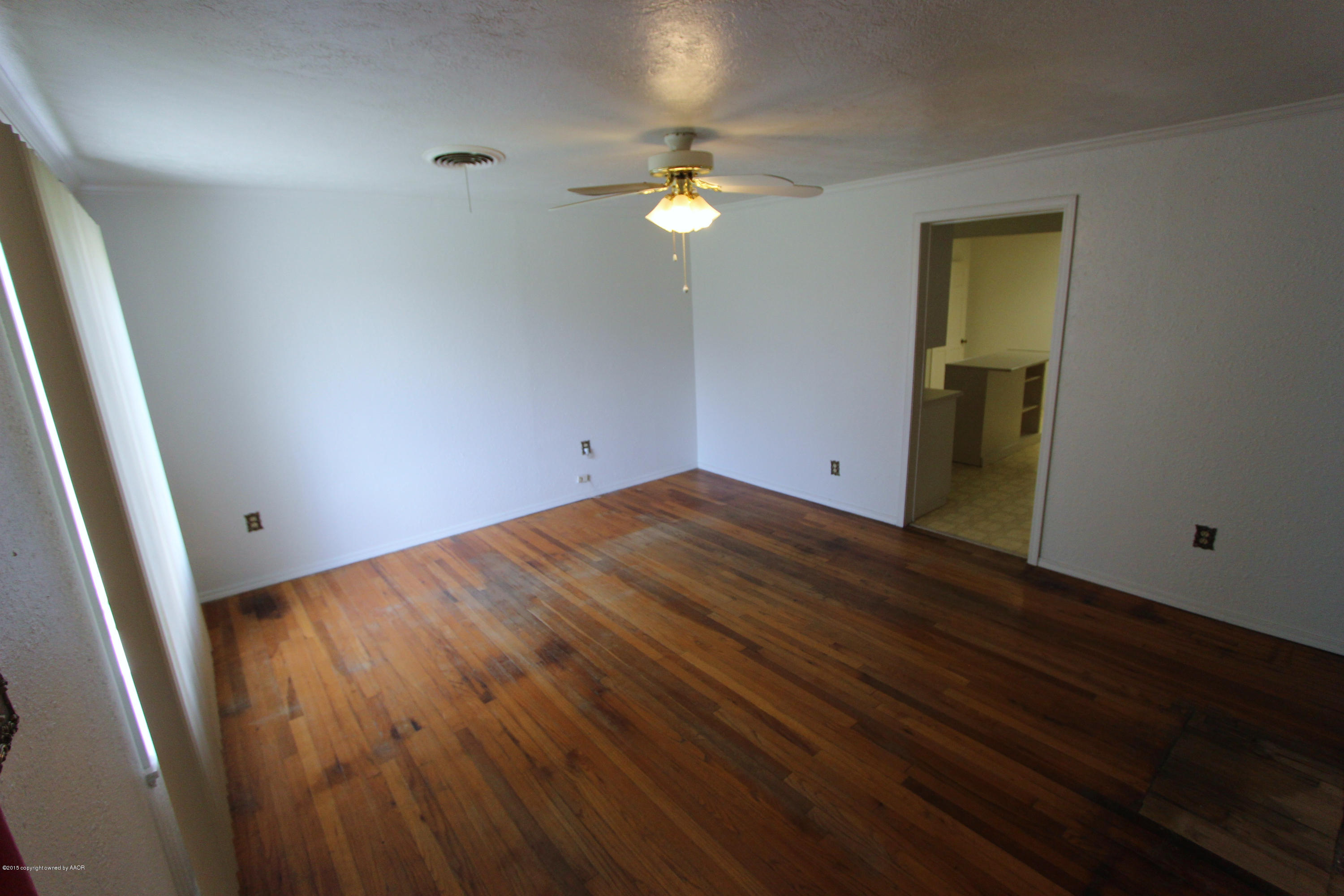 3811 South Hayden Street Amarillo, TX 79110 - Photo 3 of 18 a view of empty room with wooden floor