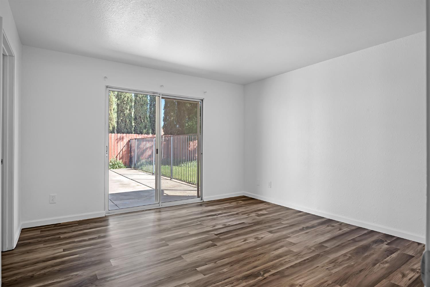 614 Brookview Court Ione, CA 95640 - Photo 14 of 24 a view of an empty room with wooden floor and a window