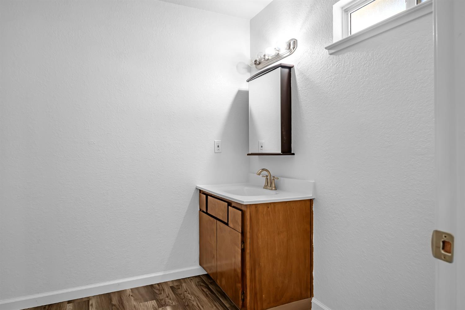 614 Brookview Court Ione, CA 95640 - Photo 16 of 24 a bathroom with a sink and a mirror