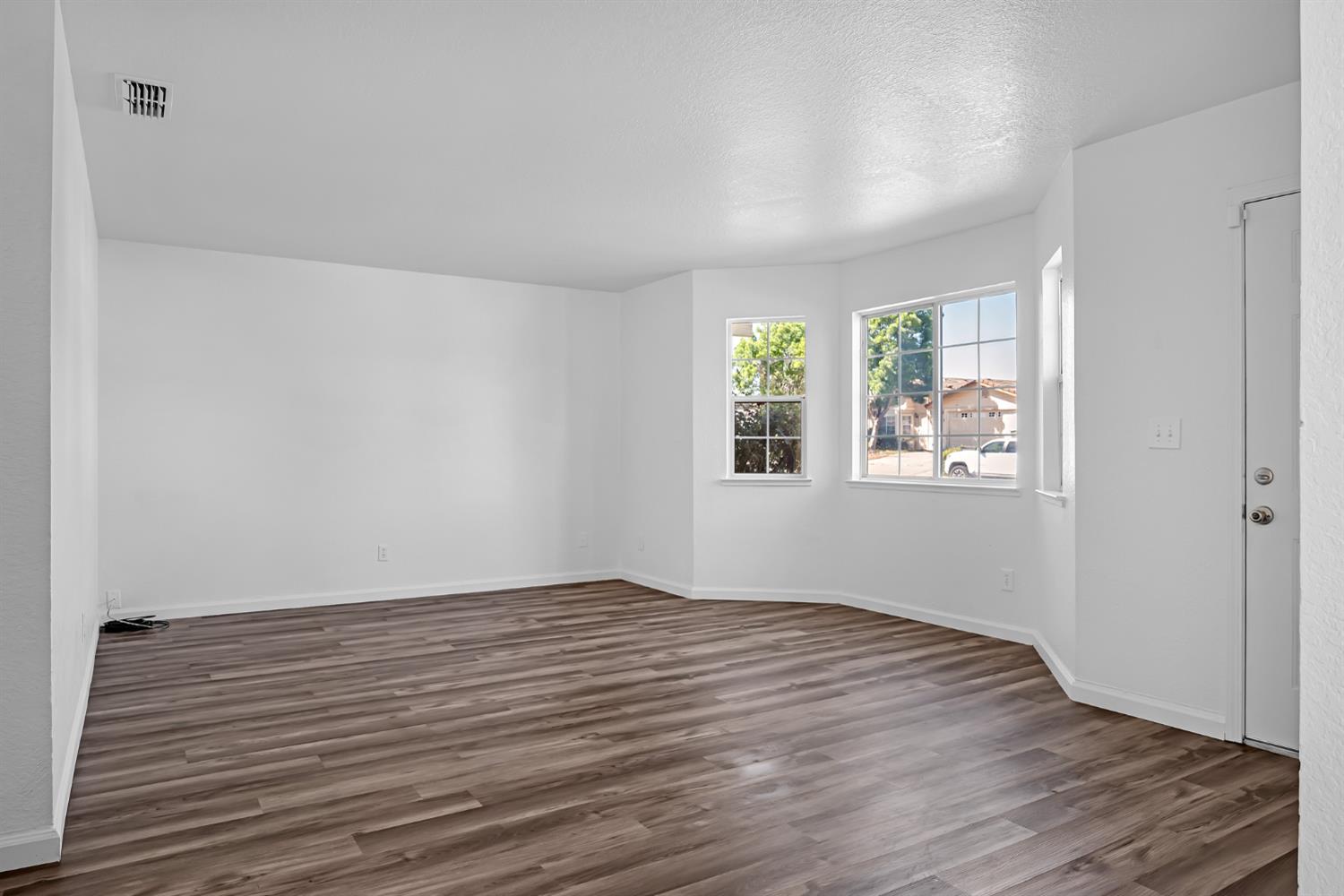 614 Brookview Court Ione, CA 95640 - Photo 3 of 24 wooden floor in an empty room with a window