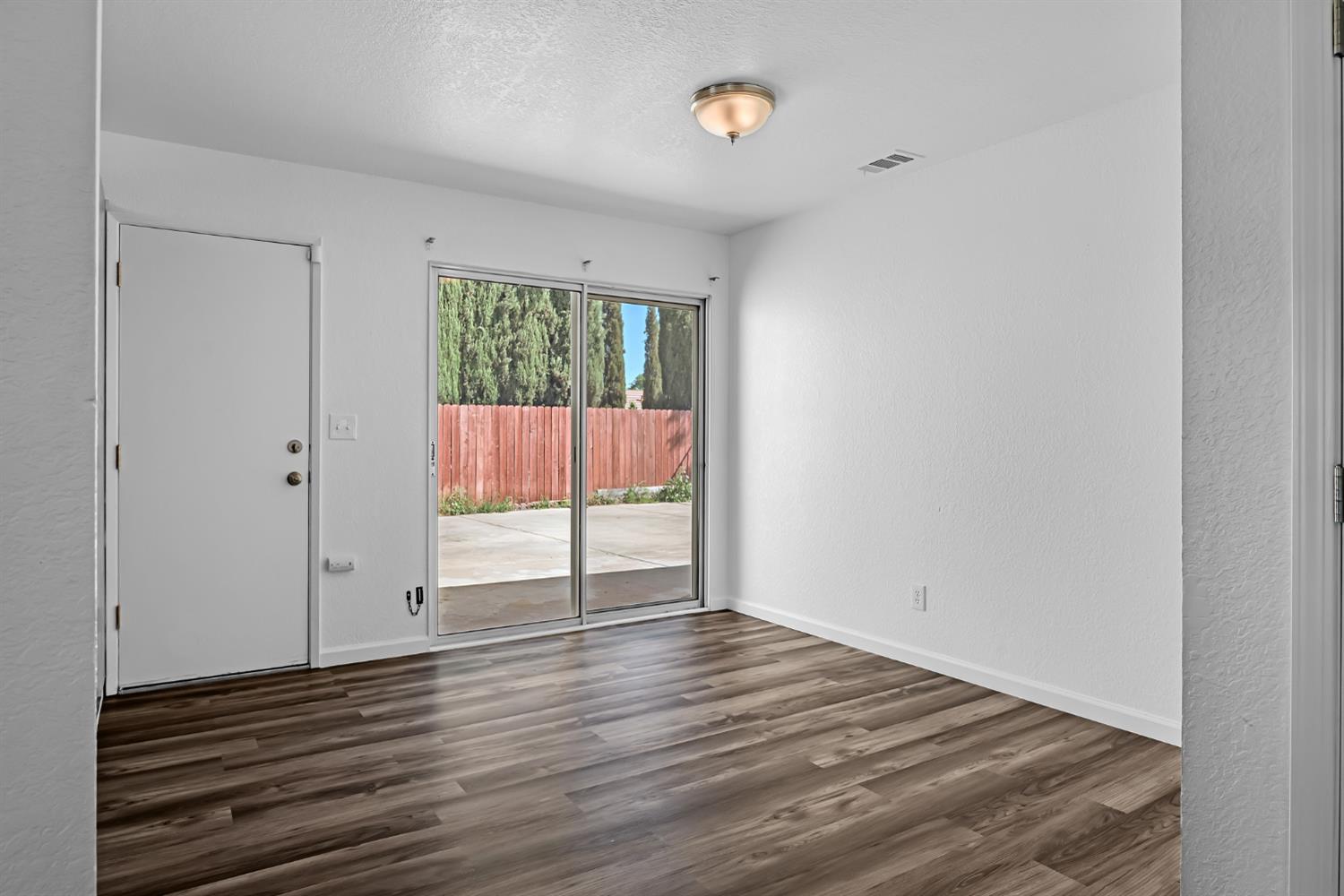 614 Brookview Court Ione, CA 95640 - Photo 5 of 24 a view of an empty room with wooden floor and a window