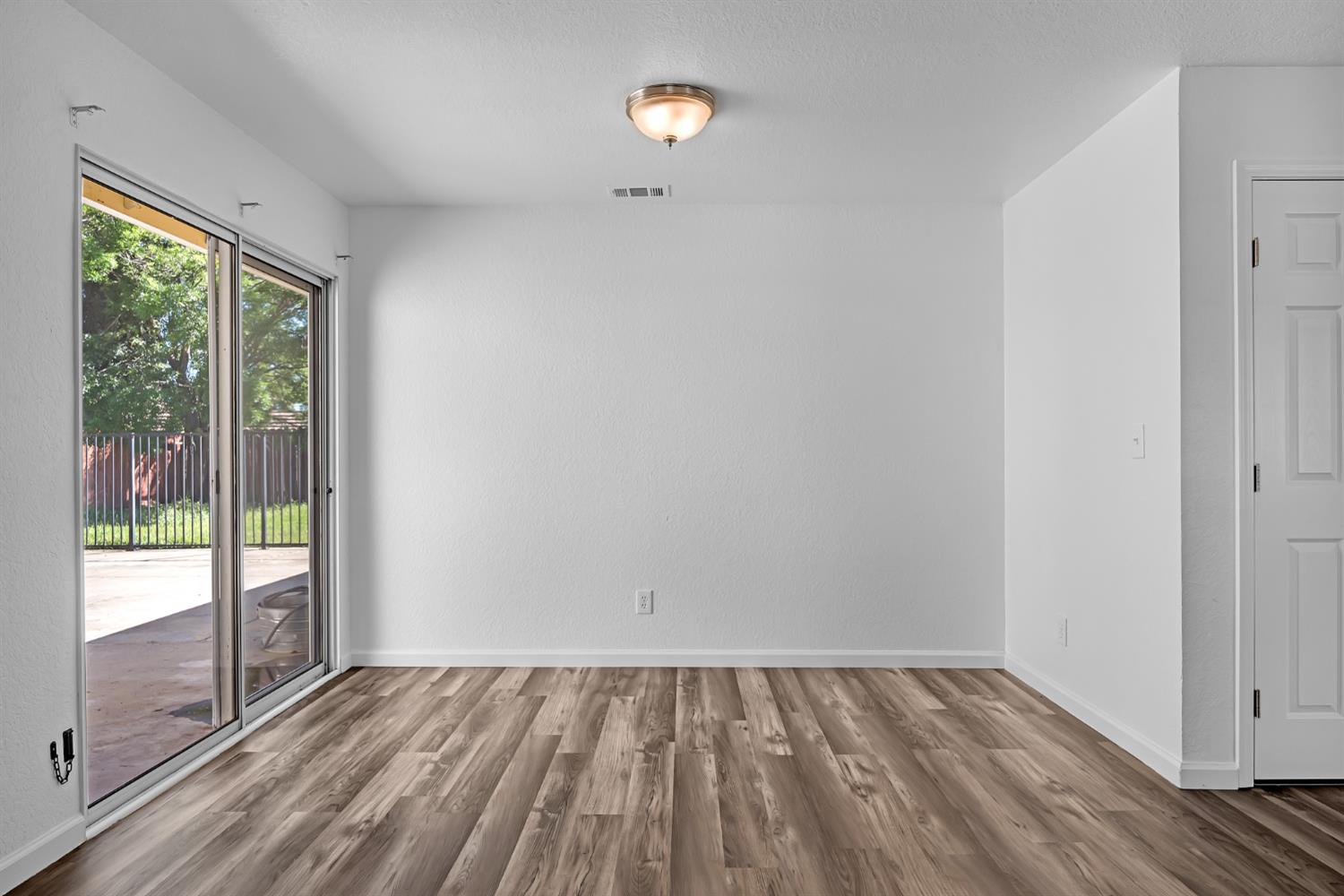 614 Brookview Court Ione, CA 95640 - Photo 6 of 24 wooden floor in an empty room with a window