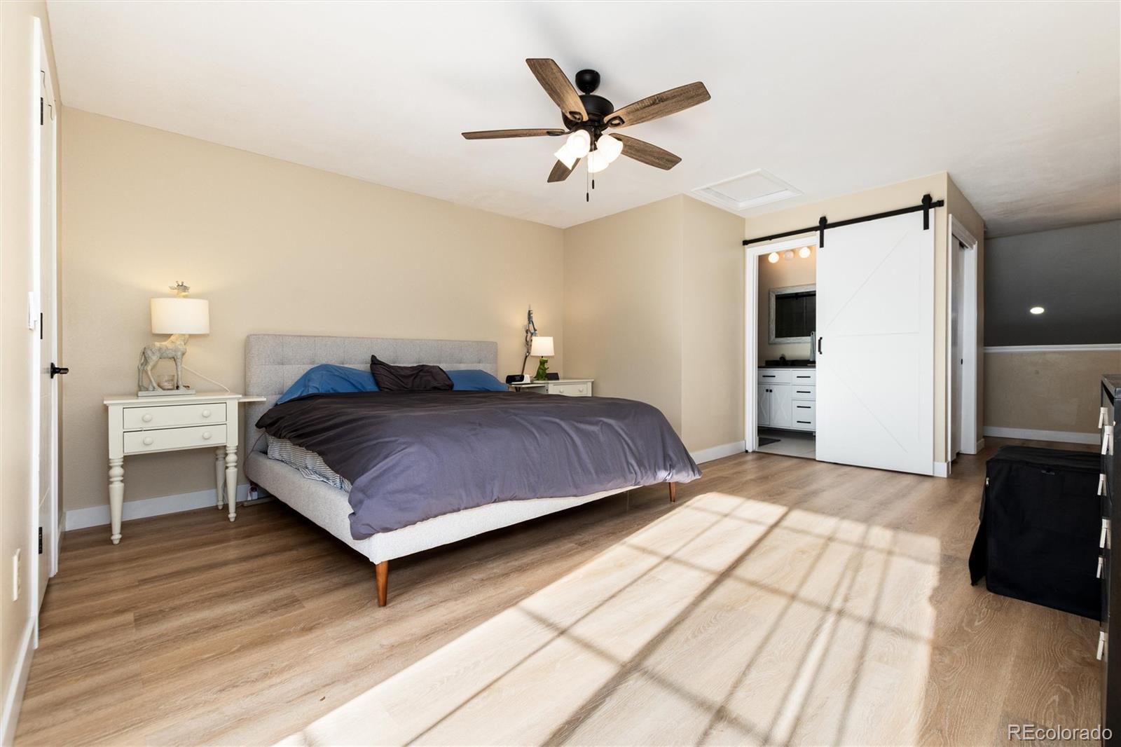 4010 South Rifle Way Aurora, CO 80013 - Photo 24 of 45 a bedroom with a bed and a ceiling fan