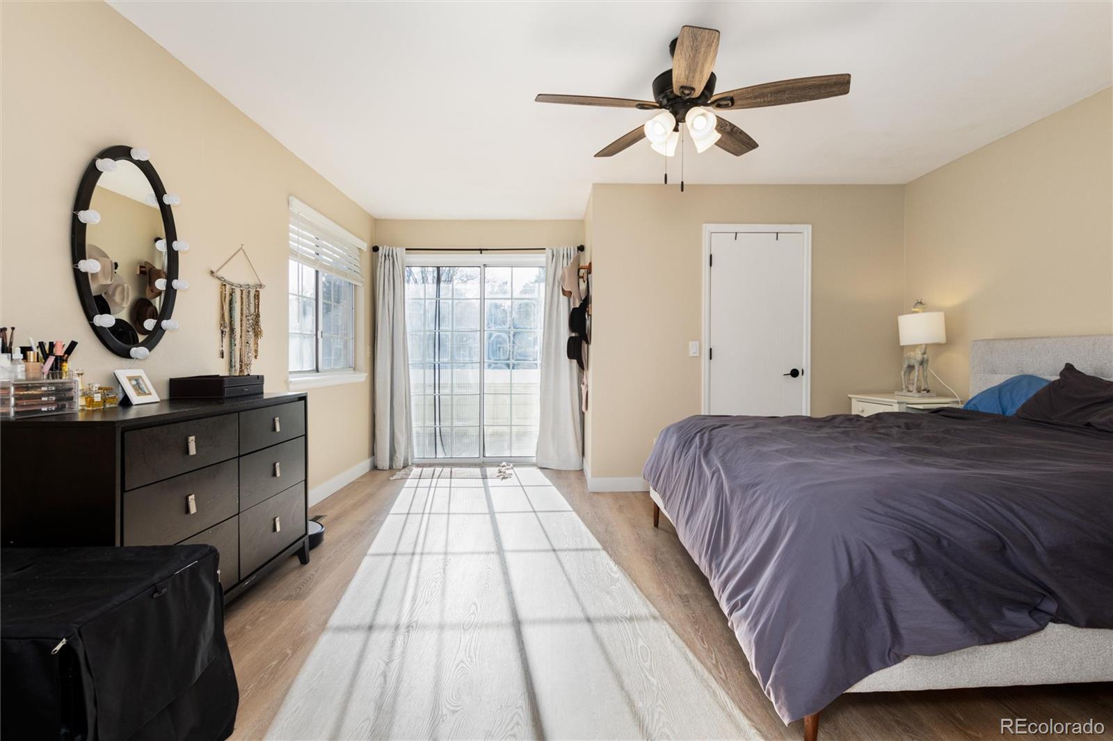 4010 South Rifle Way Aurora, CO 80013 - Photo 25 of 45 a bedroom with a large bed and a chandelier
