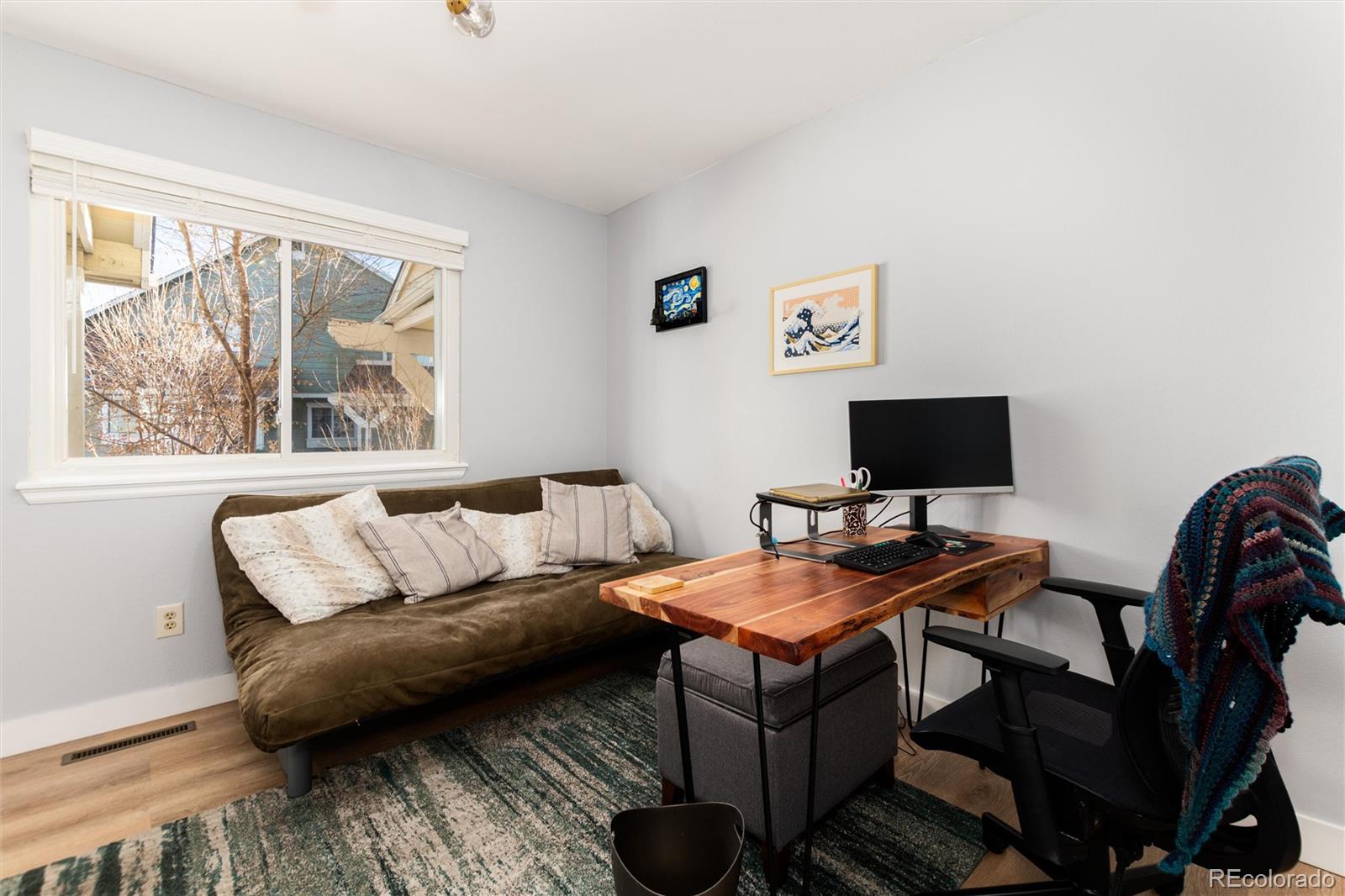 4010 South Rifle Way Aurora, CO 80013 - Photo 30 of 45 a living room with furniture and a flat screen tv