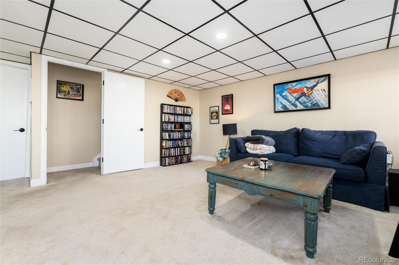 4010 South Rifle Way Aurora, CO 80013 - Photo 33 of 45 a living room with furniture a rug and a wall painting