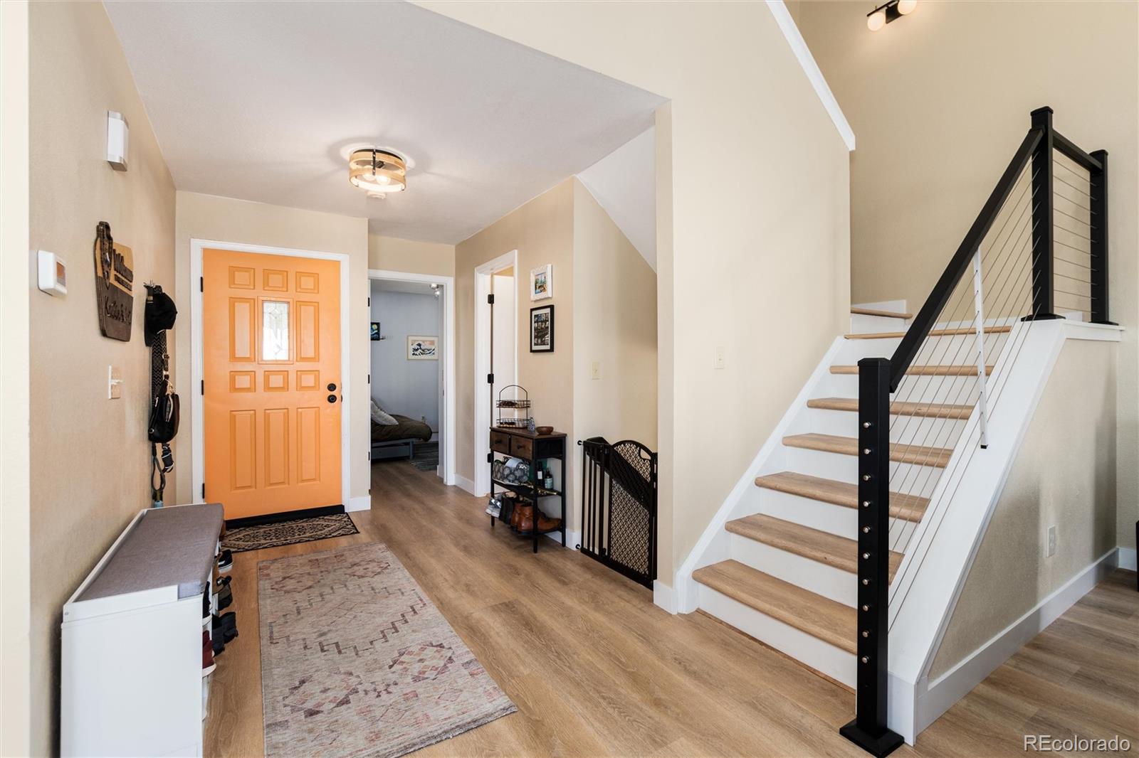 4010 South Rifle Way Aurora, CO 80013 - Photo 5 of 45 a view of a hallway with wooden floor and staircase