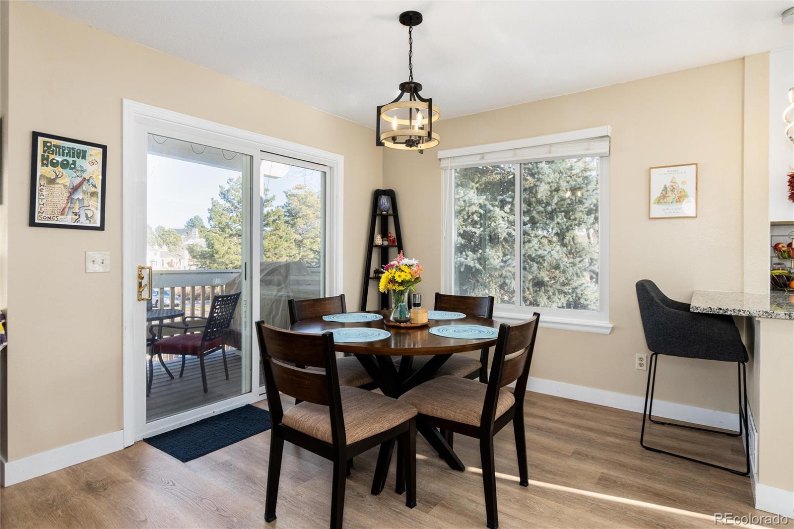 4010 South Rifle Way Aurora, CO 80013 - Photo 8 of 45 a dining room with furniture a chandelier and wooden floor