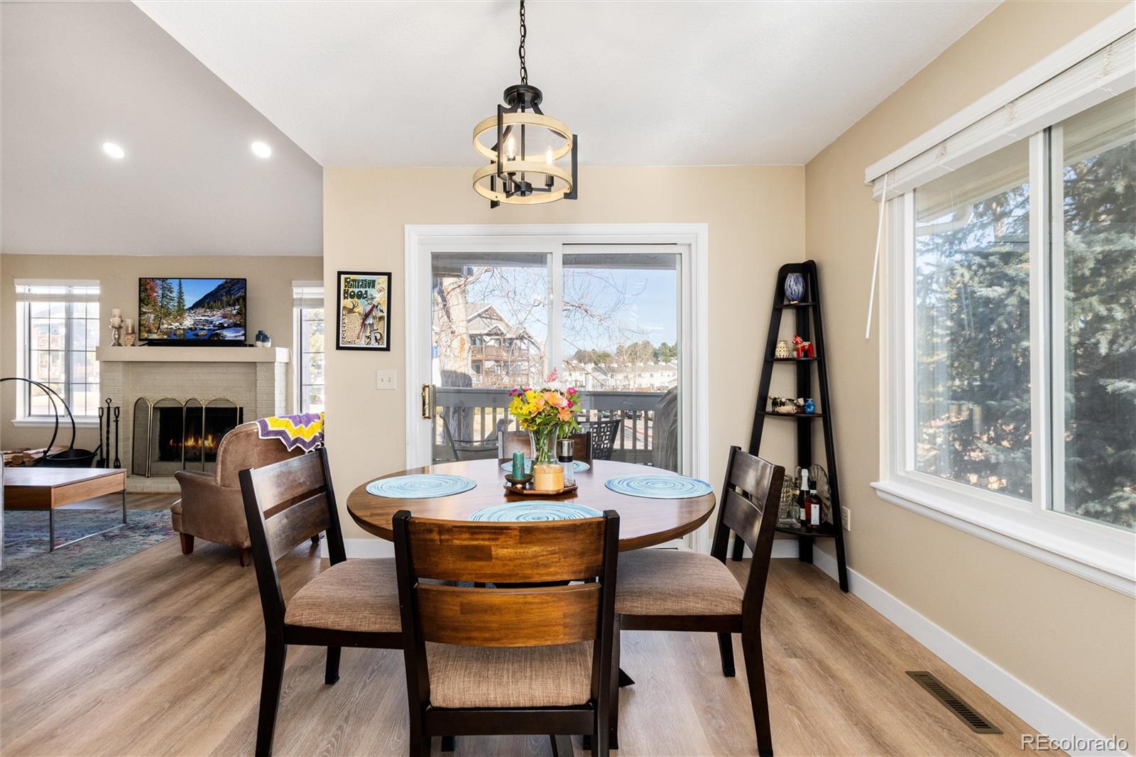 4010 South Rifle Way Aurora, CO 80013 - Photo 9 of 45 a dining room with furniture a flat screen tv and a large window